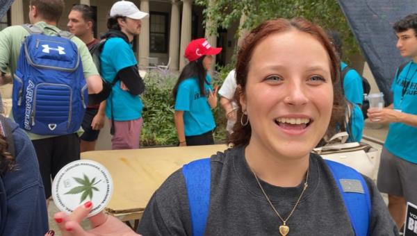 Pitt Freshman Emilia Chuhran holds a legalize marijuana sticker in the freshman quad at University of Pittsburgh.