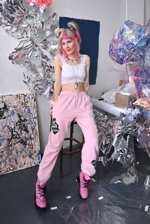 Julia Sinelnikova with pink hair and pink boots at her studio