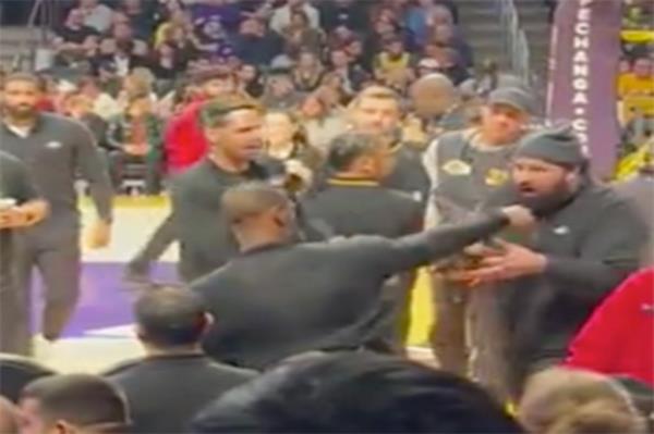 LeBron pushes the fan away.