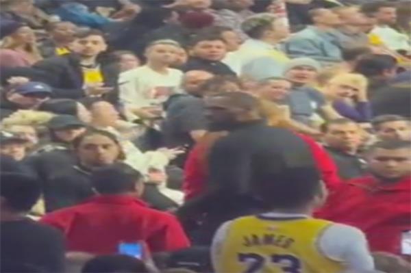 James looks in the direction of the fan.