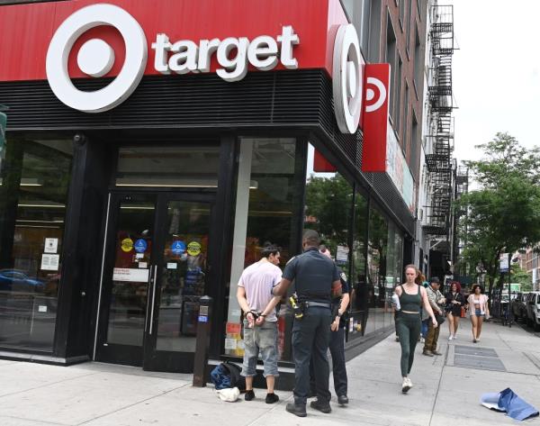 Major retailers such as Target have been especially hard hit by the nation's o<em></em>ngoing shoplifting epidemic; here, NYPD officers arrest a suspected shoplifter at a Target branch in Manhattan in May 2023.