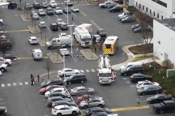 Emergency vehicles and crews can be seen in the car park as they respond to reports of a chemical smell