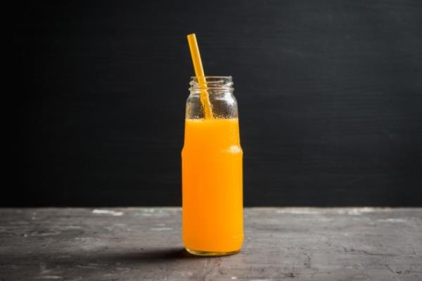 Bright pumpkin beverage in bottle