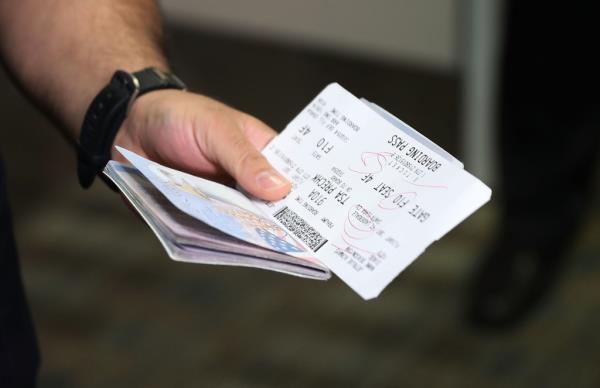 A man holding a passport. 