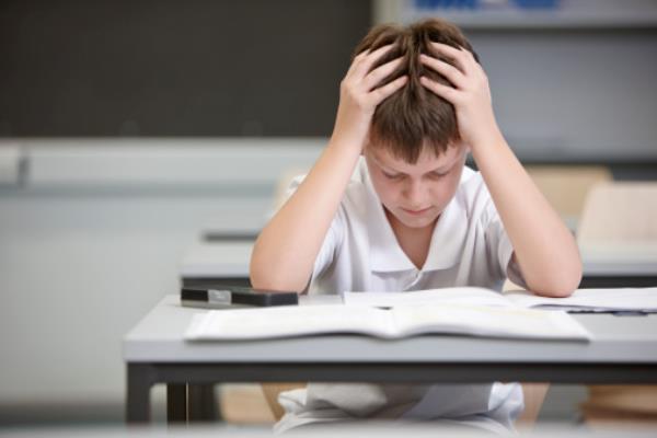 Schoolboy struggling in educatio<em></em>nal exam