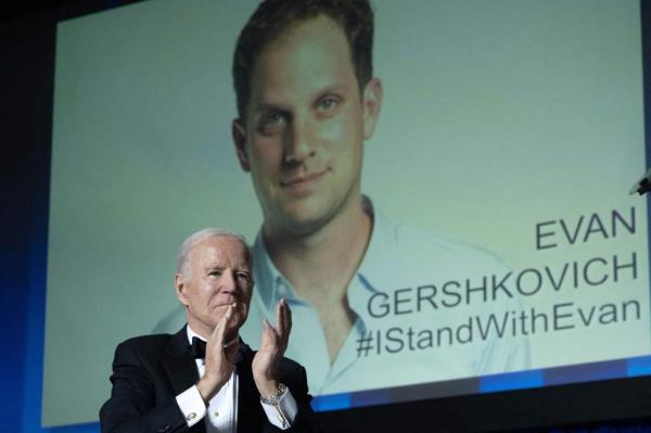 Biden applauds a tribute to Gershkovich at the White House Correspondents' Dinner in April 