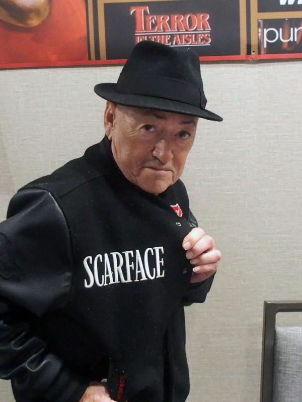 Actor Angel Salazar, known for his role in 'Scarface', wearing a black hat and jacket at the Chiller Theatre Autograph Expo Spring 2024 in Parsippany, New Jersey.