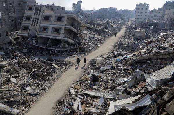 Palestinians walk past destroyed houses, amid the o<em></em>ngoing co<em></em>nflict between Israel and Hamas, in Jabalia refugee camp, in the northern Gaza Strip February 22, 2024. REUTERS/Mahmoud Issa