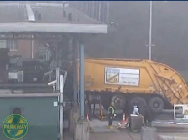 A garbage truck is shown slamming into a collector’s booth at the Barnegat Toll Plaza. 