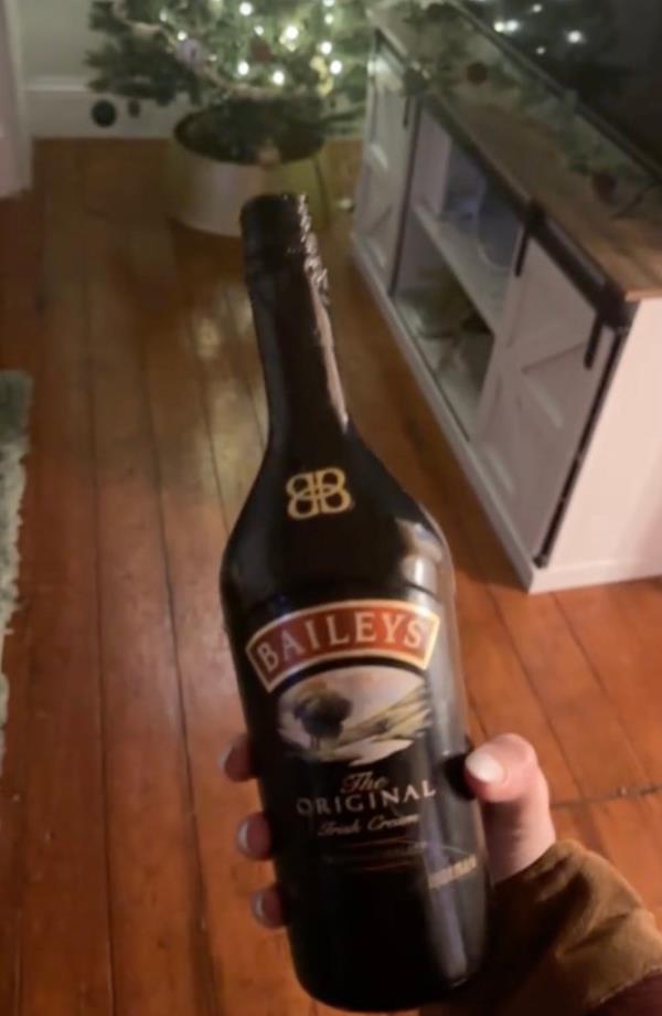 Mary holding up the Baileys bottle