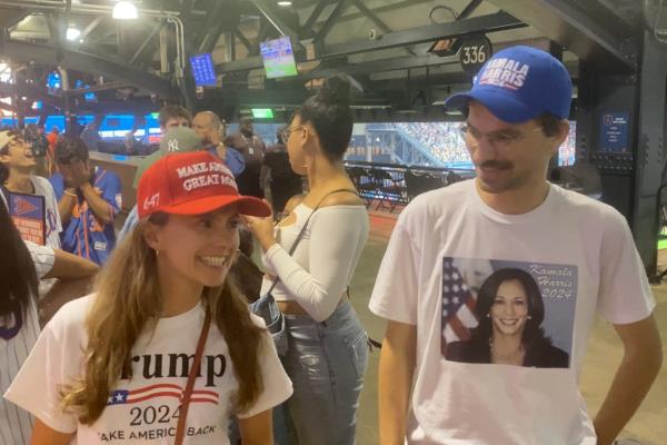 New York Post reporter wearing MAGA and Kamala Harris gear at Citi Field. 