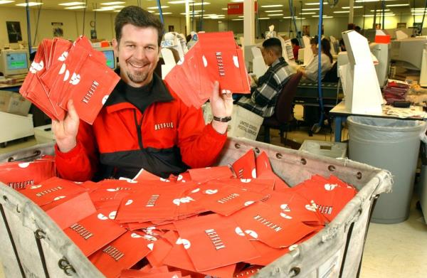 Netflix.com Chief Executive Officer Reed Hastings sits in a cart full of ready-to-be-shipped DVDs January 29, 2002 in San Jose, CA.