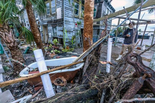 Man observing debris in Bradenton, Florida after the devastating aftermath of Hurricane Milton on October 10, 2024.