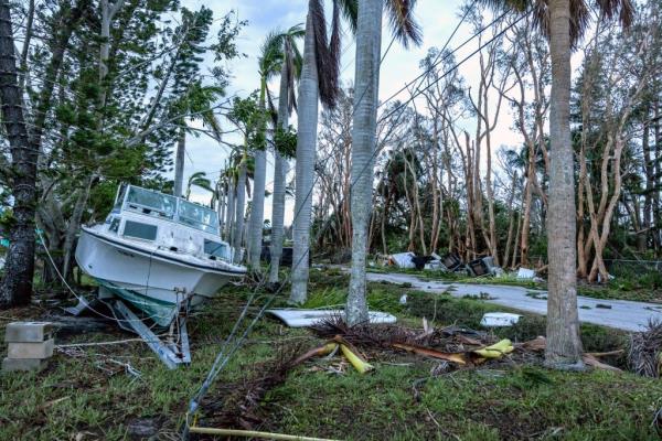 A boat stranded on roadside amidst debris in Bradenton, Florida after Hurricane Milton, dated 10 October 2024