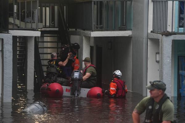 Residents being rescued from a flooded second story apartment complex in Clearwater, Florida due to Hurricane Milton in October 2024, with celebrity Bear Pascoe present