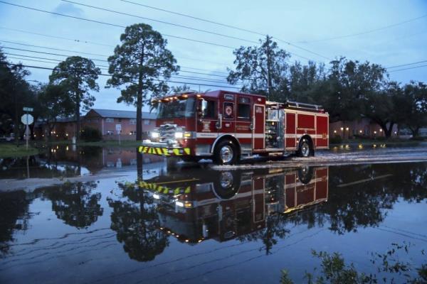 Firetruck driving through a flooded street in St. Petersburg, Florida due to Hurricane Milton on October 10, 2024