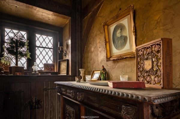 A portrait hangs above the mantle. 