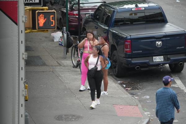 Women gathered at the intersection of Elmhurst Avenue and Case Street in Queens at the infamous 