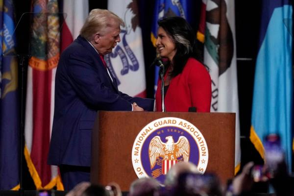 Do<em></em>nald Trump shakes hands with former Democratic Rep. Tulsi Gabbard, who endorsed Trump, at the Natio<em></em>nal Guard Association of the United States' 146th General Conference, Monday, Aug. 26, 2024.