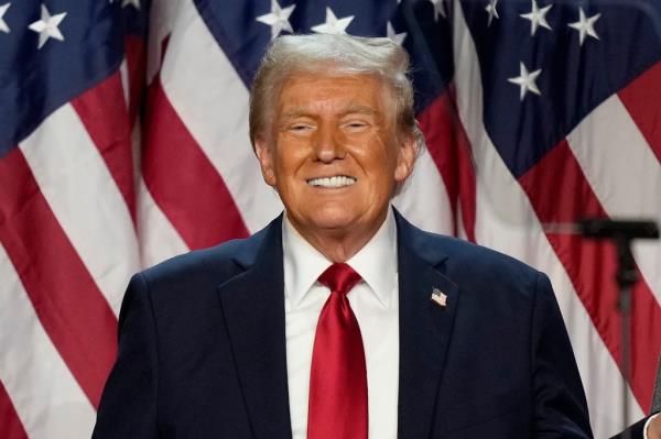 Trump smiling in suit and tie on Nov. 6, 2024 in Palm Beach after winning election.