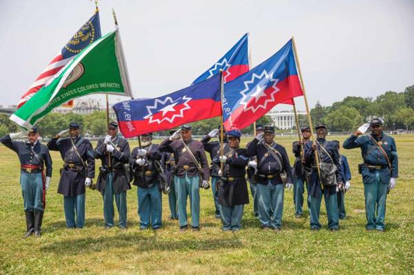 Members of a Civil War re-enactment troop are seen with the White House in the background during Juneteenth celebrations in Washington, D.C., the United States, on June 19, 2023