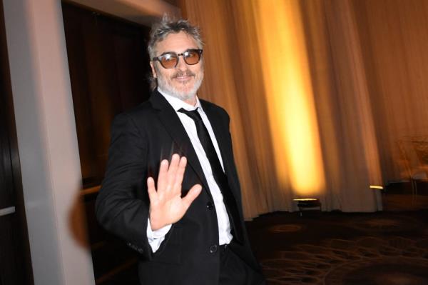 US actor Joaquin Phoenix poses at the Ballroom entrance of the 81st annual Golden Globe Awards at The Beverly Hilton hotel in Beverly Hills, California, on January 7, 2024.