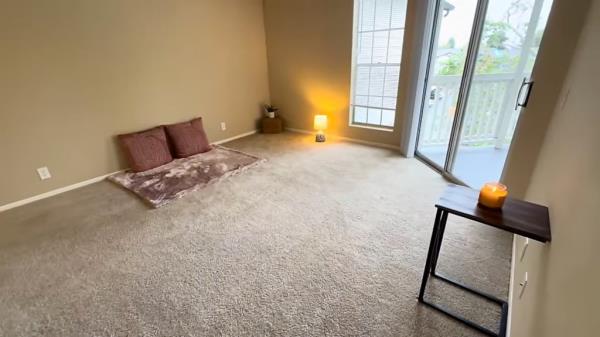 A minimalist woman's room with a glass door and a window in an expensive city, San Diego