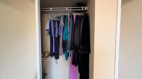 A minimalist's closet with few clothes, symbolizing Alicia Rice's frugal lifestyle in an expensive city