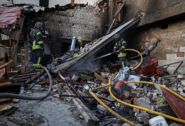 Rescuers work through the debris following a Russian military strike in Kherson, Ukraine on Dec. 27, 2023.
