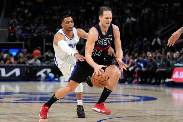 Detroit Pistons forward Bojan Bogdanovic (44) drives on Los Angeles Clippers guard Russell Westbrook (0) in an NBA basketball game.