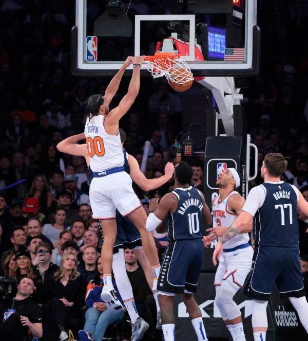 New York Knicks forward Jacob Toppin #00 dunking a basketball in the 4th quarter against Dallas Mavericks at Madison Square Garden.