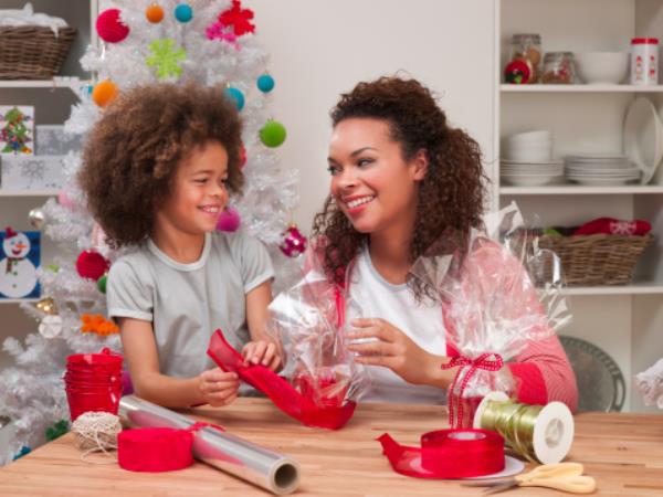 Woman and son wrapping Christmas presents