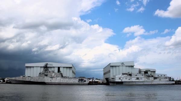 A Littoral Combat Ship, left, and an Expeditio<em></em>nary Fast Transport sit docked at Austal USA's shipyard on the Mobile River opposite downtown Mobile.