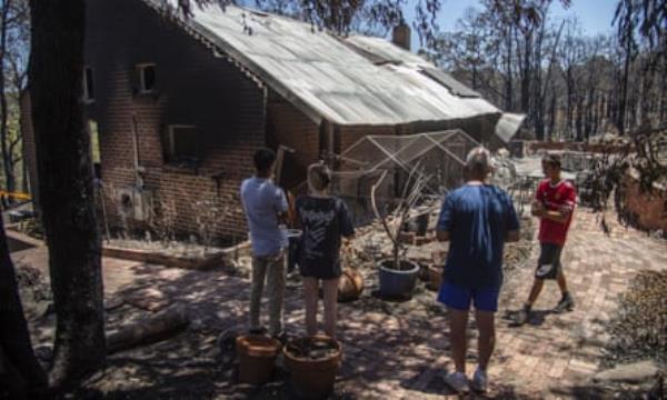 Local resident Mark Norton inspects his home that was destroyed by a bushfire at Parkerville in Perth